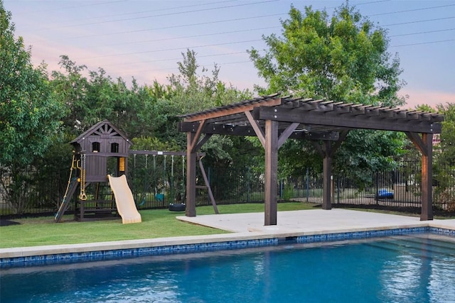 405 Maialina Cv, Lakeway, TX 78738 - pool at dusk with a pergola, a playground, and a patio area