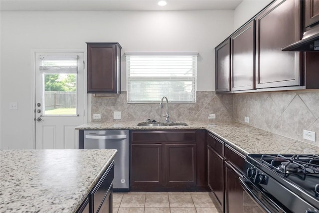 10205 Gertrudis Loop, Austin, TX 78747 - kitchen featuring dishwasher, black range with gas cooktop, backsplash, dark brown cabinets, and light tile patterned floors