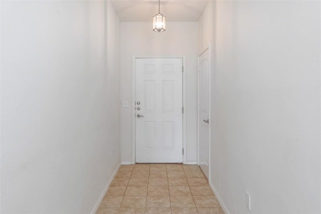 10205 Gertrudis Loop, Austin, TX 78747 - doorway with baseboards and light tile patterned floors