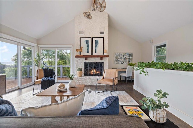 19426 Fisher Ln, Spicewood, TX 78669 - living area with high vaulted ceiling, a fireplace, and wood finished floors