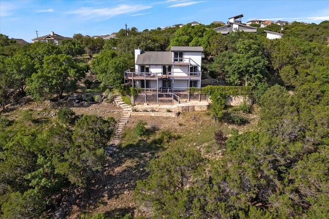 19426 Fisher Ln, Spicewood, TX 78669 - back of house featuring stairway, a chimney, and a balcony
