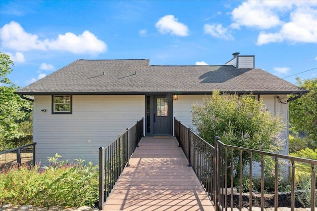 19426 Fisher Ln, Spicewood, TX 78669 - view of front of home featuring roof with shingles and a chimney