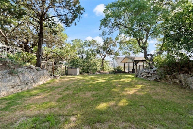 19426 Fisher Ln, Spicewood, TX 78669 - view of grassy yard featuring a storage unit