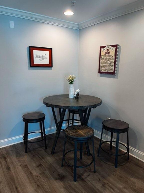 1725 Harvey Mitchell Pkwy S Unit 225, College Station, TX 77840 - dining space featuring ornamental molding and dark wood-style floors