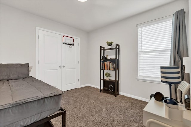202 Grapefruit Rd, Hutto, TX 78634 - bedroom featuring dark carpet and baseboards