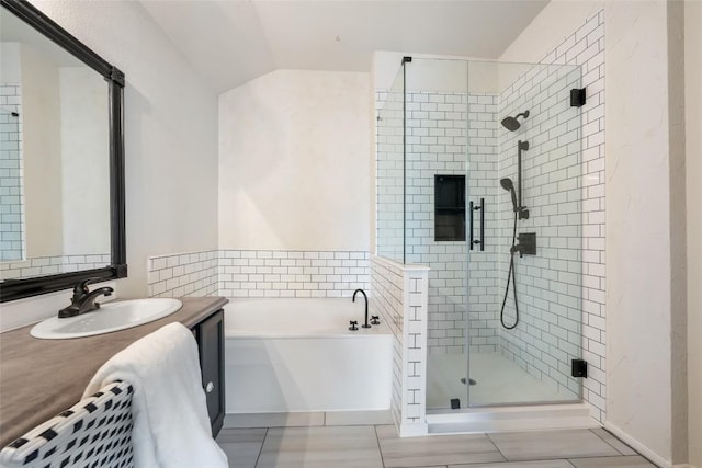 903 Thackeray Ln, Pflugerville, TX 78660 - bathroom featuring a stall shower, a bath, vanity, vaulted ceiling, and tile patterned flooring