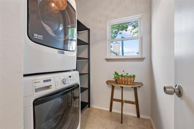 903 Thackeray Ln, Pflugerville, TX 78660 - laundry area featuring stacked washer and clothes dryer and baseboards