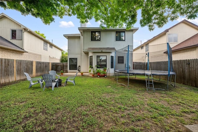 903 Thackeray Ln, Pflugerville, TX 78660 - rear view of property with a trampoline and a fenced backyard