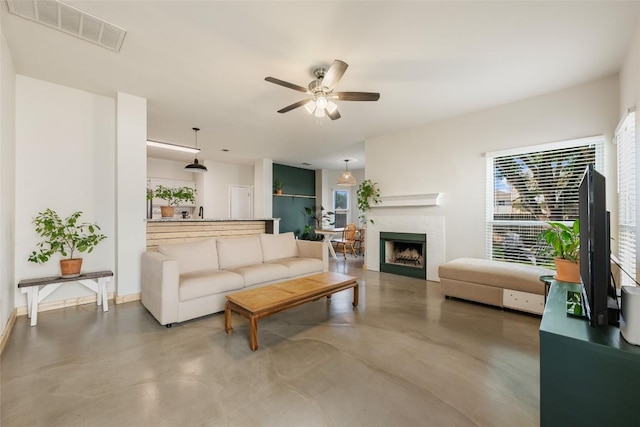903 Thackeray Ln, Pflugerville, TX 78660 - living room featuring healthy amount of natural light, a ceiling fan, and finished concrete floors