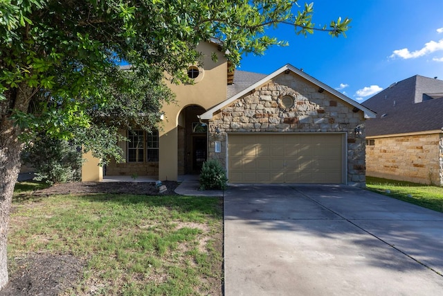 3604 Rosalina Loop, Round Rock, TX 78665 - view of front facade with stone siding, a garage, concrete driveway, and stucco siding