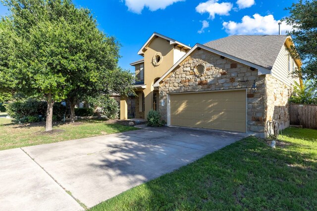 3604 Rosalina Loop, Round Rock, TX 78665 - view of front of house with stone siding, an attached garage, driveway, and a front lawn