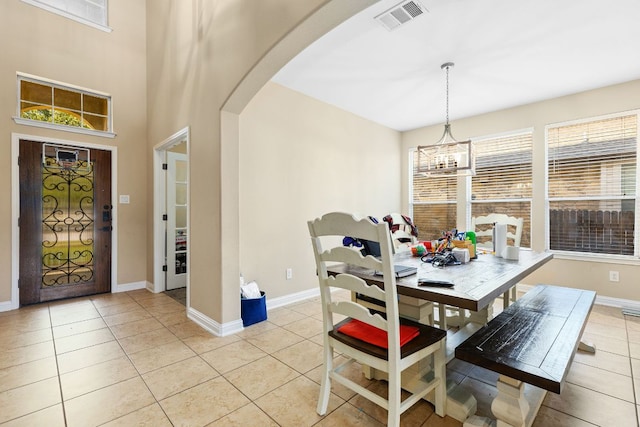 3604 Rosalina Loop, Round Rock, TX 78665 - dining area with arched walkways, light tile patterned floors, and a chandelier