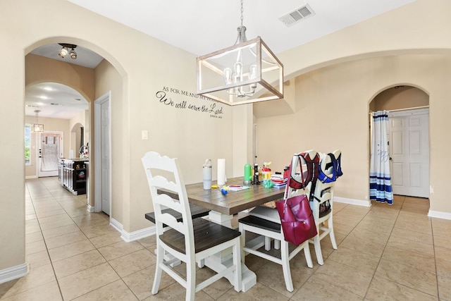3604 Rosalina Loop, Round Rock, TX 78665 - dining room featuring light tile patterned floors, a chandelier, and arched walkways