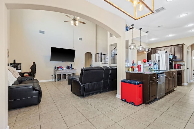 3604 Rosalina Loop, Round Rock, TX 78665 - living area with arched walkways, a ceiling fan, light tile patterned flooring, recessed lighting, and a high ceiling