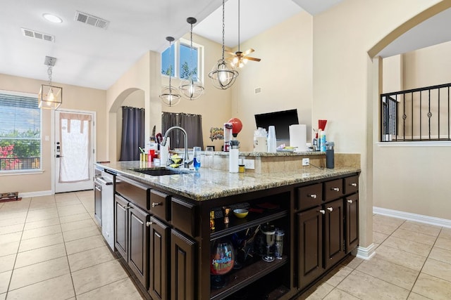 3604 Rosalina Loop, Round Rock, TX 78665 - kitchen featuring light tile patterned floors, arched walkways, and pendant lighting