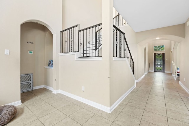 3604 Rosalina Loop, Round Rock, TX 78665 - entrance foyer with arched walkways, tile patterned floors, a towering ceiling, and stairs