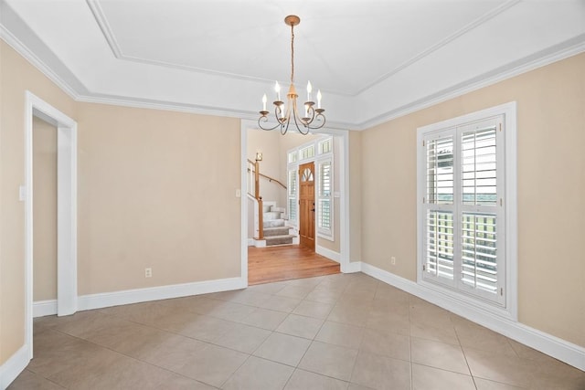 310 County Road 317, Georgetown, TX 78626 - empty room featuring plenty of natural light, stairs, a chandelier, crown molding, and a tray ceiling