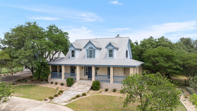 310 County Road 317, Georgetown, TX 78626 - view of front facade featuring a porch, stone siding, and a metal roof