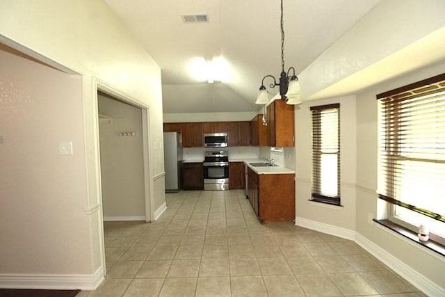 213 Bronc Dr, Copperas Cove, TX 76522 - kitchen featuring stainless steel appliances, vaulted ceiling, a chandelier, light countertops, and light tile patterned flooring