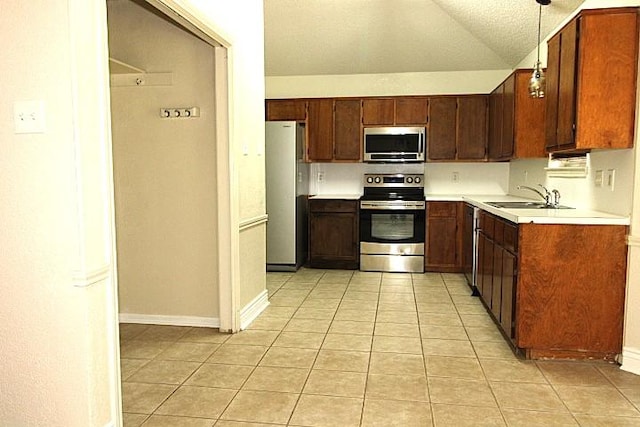 213 Bronc Dr, Copperas Cove, TX 76522 - kitchen featuring stainless steel appliances, light tile patterned floors, light countertops, decorative light fixtures, and lofted ceiling