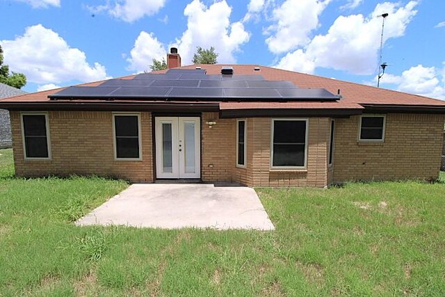 213 Bronc Dr, Copperas Cove, TX 76522 - back of house with a chimney, french doors, brick siding, and a patio area