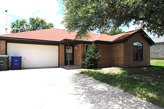 213 Bronc Dr, Copperas Cove, TX 76522 - ranch-style house with concrete driveway, brick siding, and an attached garage