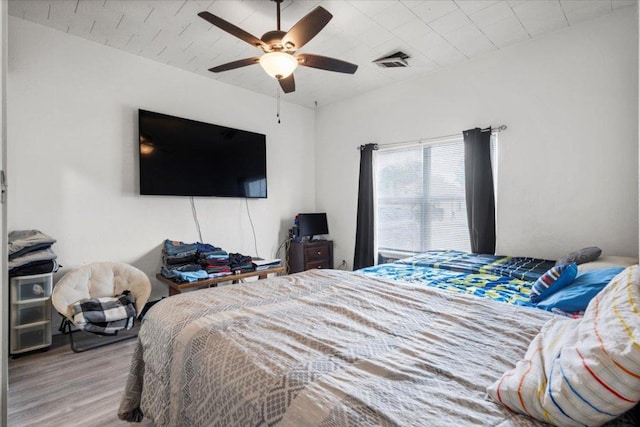 909 W 3rd St, Taylor, TX 76574 - bedroom featuring wood finished floors and a ceiling fan