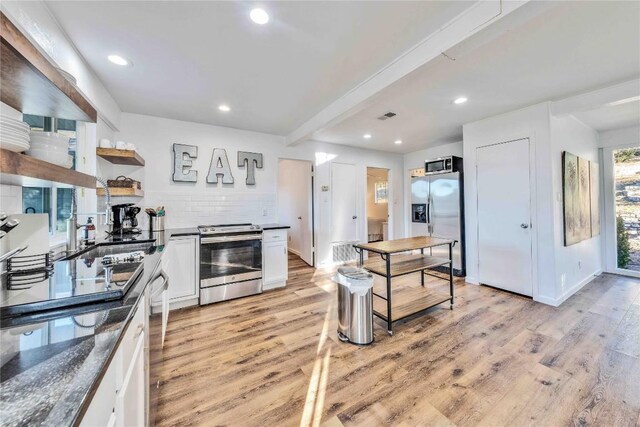 10902 Beach Rd, Leander, TX 78641 - kitchen with stainless steel appliances, dark countertops, white cabinetry, light wood-type flooring, and open shelves