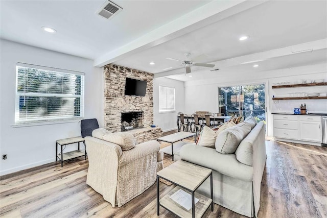 10902 Beach Rd, Leander, TX 78641 - living room featuring light wood-style flooring, beam ceiling, a fireplace, a ceiling fan, and recessed lighting