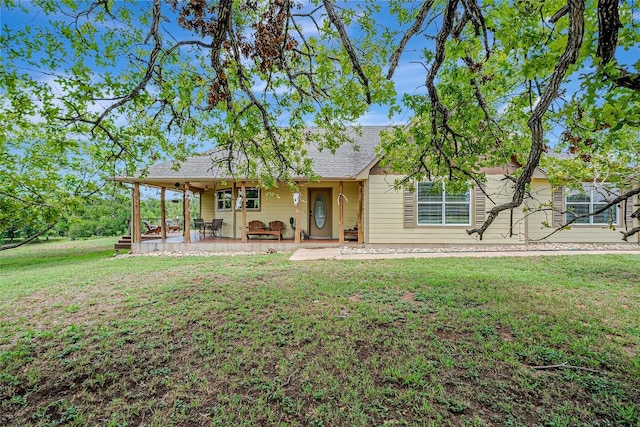 255 Mesquite Dr, Cedar Creek, TX 78612 - rear view of house with a yard and roof with shingles