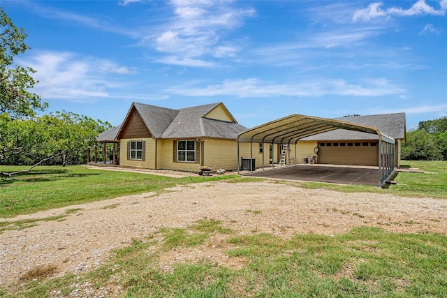 255 Mesquite Dr, Cedar Creek, TX 78612 - view of front of property with dirt driveway, a front yard, a carport, and a garage