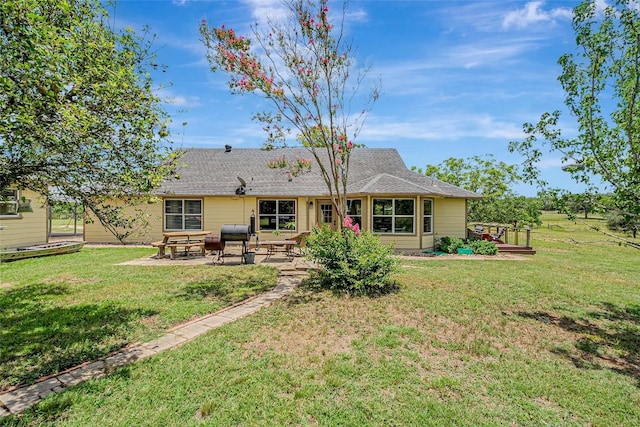 255 Mesquite Dr, Cedar Creek, TX 78612 - back of property featuring a patio and a yard