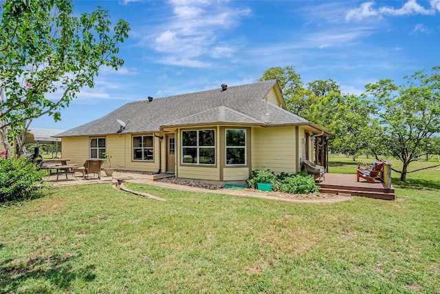 255 Mesquite Dr, Cedar Creek, TX 78612 - rear view of property featuring a wooden deck, a patio, a yard, and a shingled roof