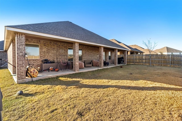 5867 Copano Loop, Belton, TX 76513 - back of property featuring brick siding, a fenced backyard, and a patio