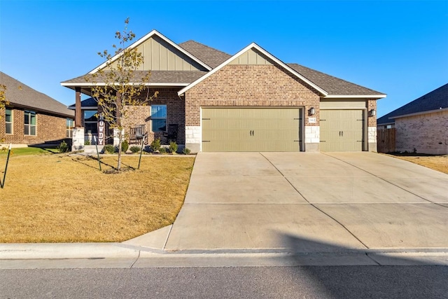 5867 Copano Loop, Belton, TX 76513 - craftsman-style house featuring board and batten siding, brick siding, an attached garage, driveway, and a front yard