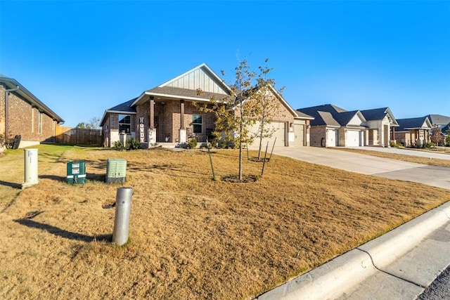 5867 Copano Loop, Belton, TX 76513 - view of front of property with a garage, driveway, brick siding, board and batten siding, and a residential view