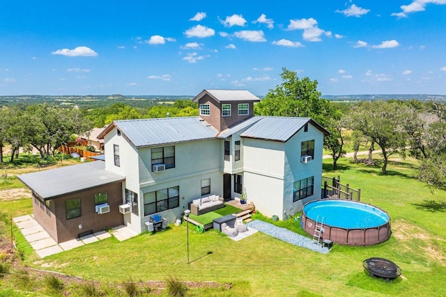 362 Oak Haven Rd, Fredericksburg, TX 78624 - back of house with an outdoor living space with a fire pit, an outdoor pool, a yard, and a patio