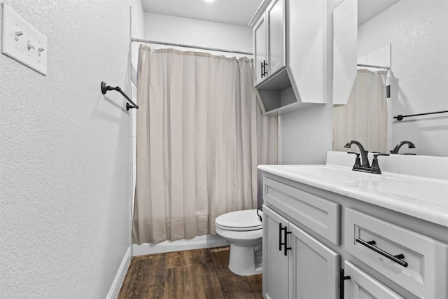7516 Hardin Dr, Temple, TX 76502 - bathroom with vanity, a textured wall, wood finished floors, and shower / tub combo with curtain