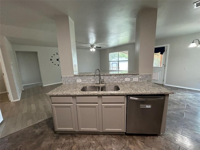 2101 Whistling Way, Taylor, TX 76574 - kitchen with dishwasher, tasteful backsplash, light stone counters, and a ceiling fan