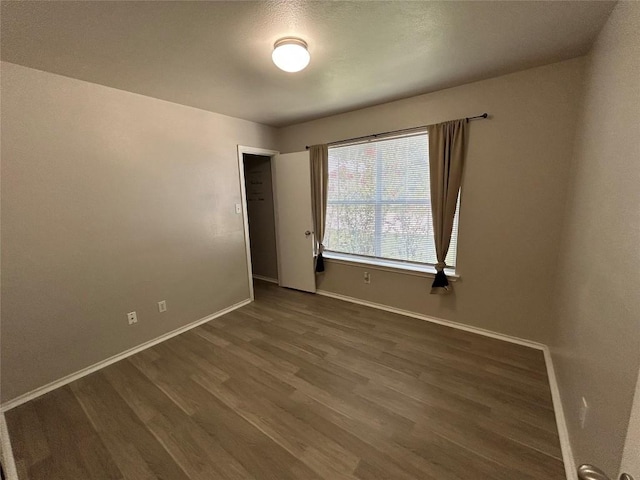 2101 Whistling Way, Taylor, TX 76574 - unfurnished room with dark wood-style floors and baseboards