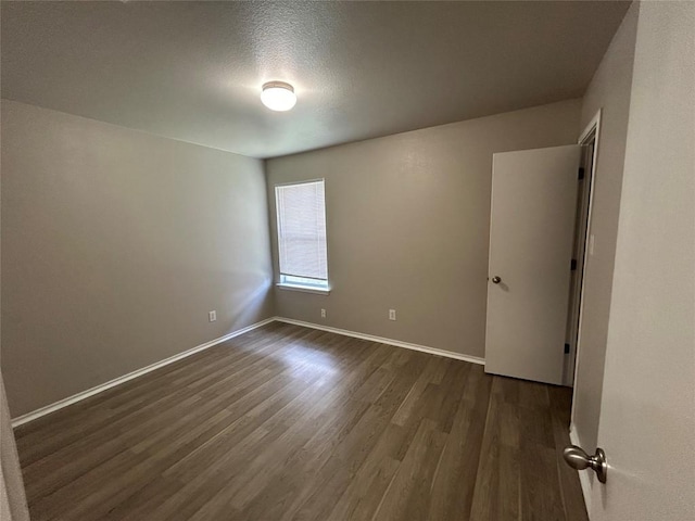2101 Whistling Way, Taylor, TX 76574 - empty room with dark wood-style flooring and baseboards