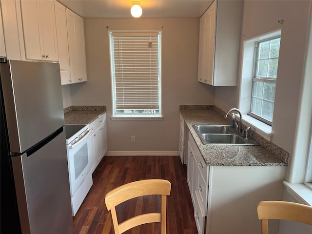 3819 Ranch Road 620th Rd N, Austin, TX 78734 - kitchen with freestanding refrigerator, white electric range oven, dark wood-type flooring, and white cabinets