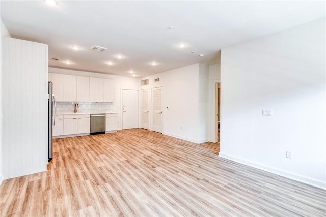 4802 S Congress Ave Unit 217, Austin, TX 78745 - unfurnished living room with light wood-style floors and recessed lighting