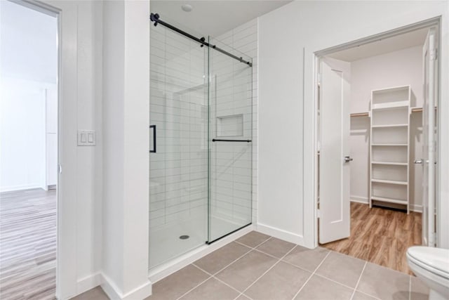 4802 S Congress Ave Unit 217, Austin, TX 78745 - full bathroom with a shower stall, a spacious closet, and wood finished floors