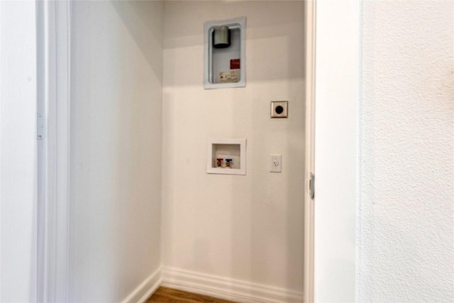 4802 S Congress Ave Unit 217, Austin, TX 78745 - washroom featuring electric dryer hookup, hookup for a washing machine, and wood finished floors