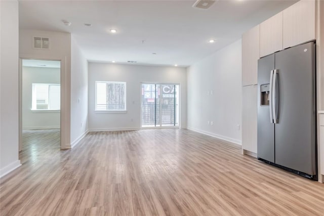 4802 S Congress Ave Unit 217, Austin, TX 78745 - unfurnished living room with light wood-type flooring and recessed lighting