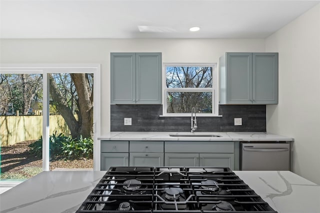 9417 N Creek Dr, Austin, TX 78753 - kitchen featuring black gas stovetop, gray cabinets, tasteful backsplash, dishwasher, and light stone countertops