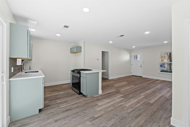 9417 N Creek Dr, Austin, TX 78753 - kitchen featuring gas stove, light wood-style flooring, light countertops, and recessed lighting