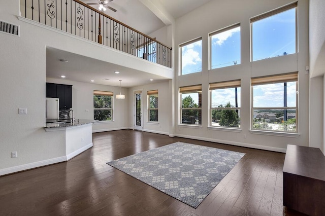 2521 Blended Tree Ranch Dr, Leander, TX 78641 - living room featuring a towering ceiling, dark wood finished floors, and a ceiling fan