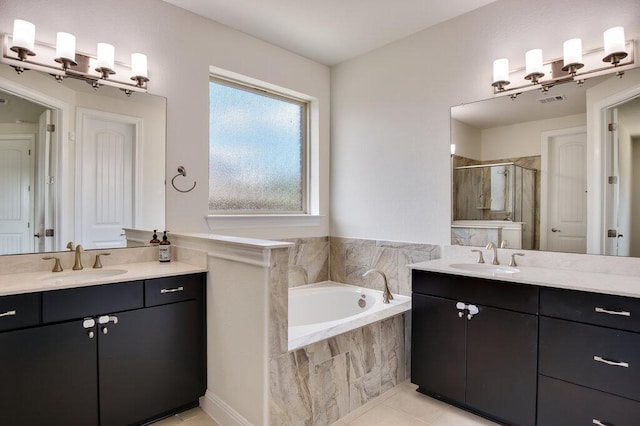 2521 Blended Tree Ranch Dr, Leander, TX 78641 - bathroom with a stall shower, two vanities, a bath, and tile patterned flooring